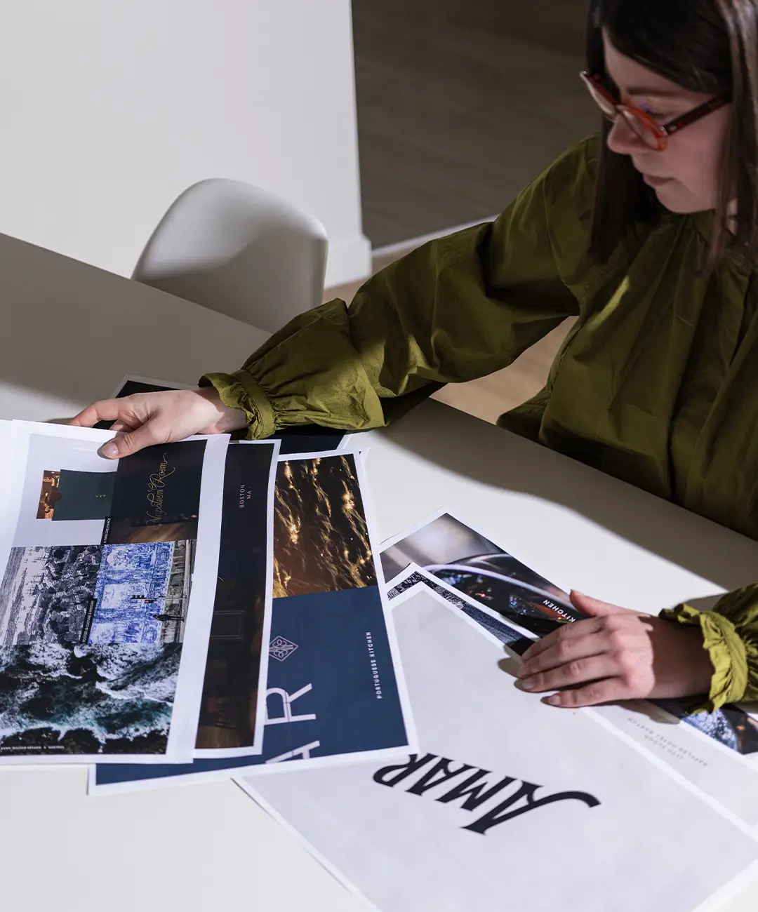 Team member reviewing work at table.