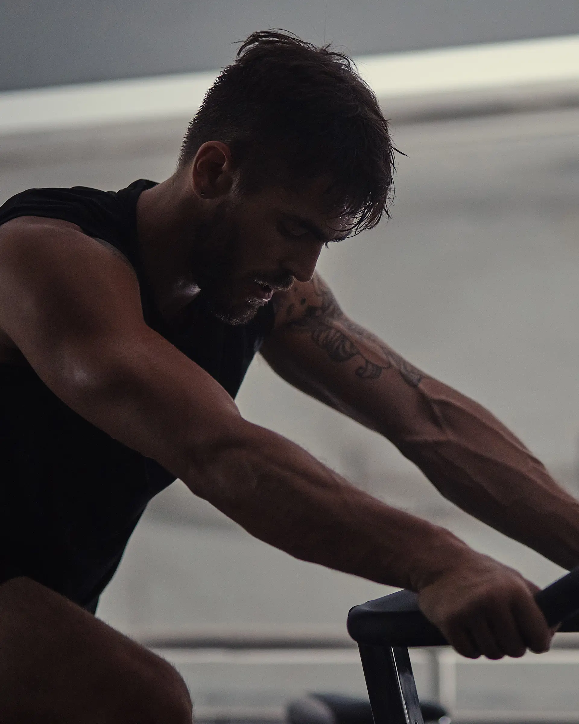 A man sweating during a spin class.