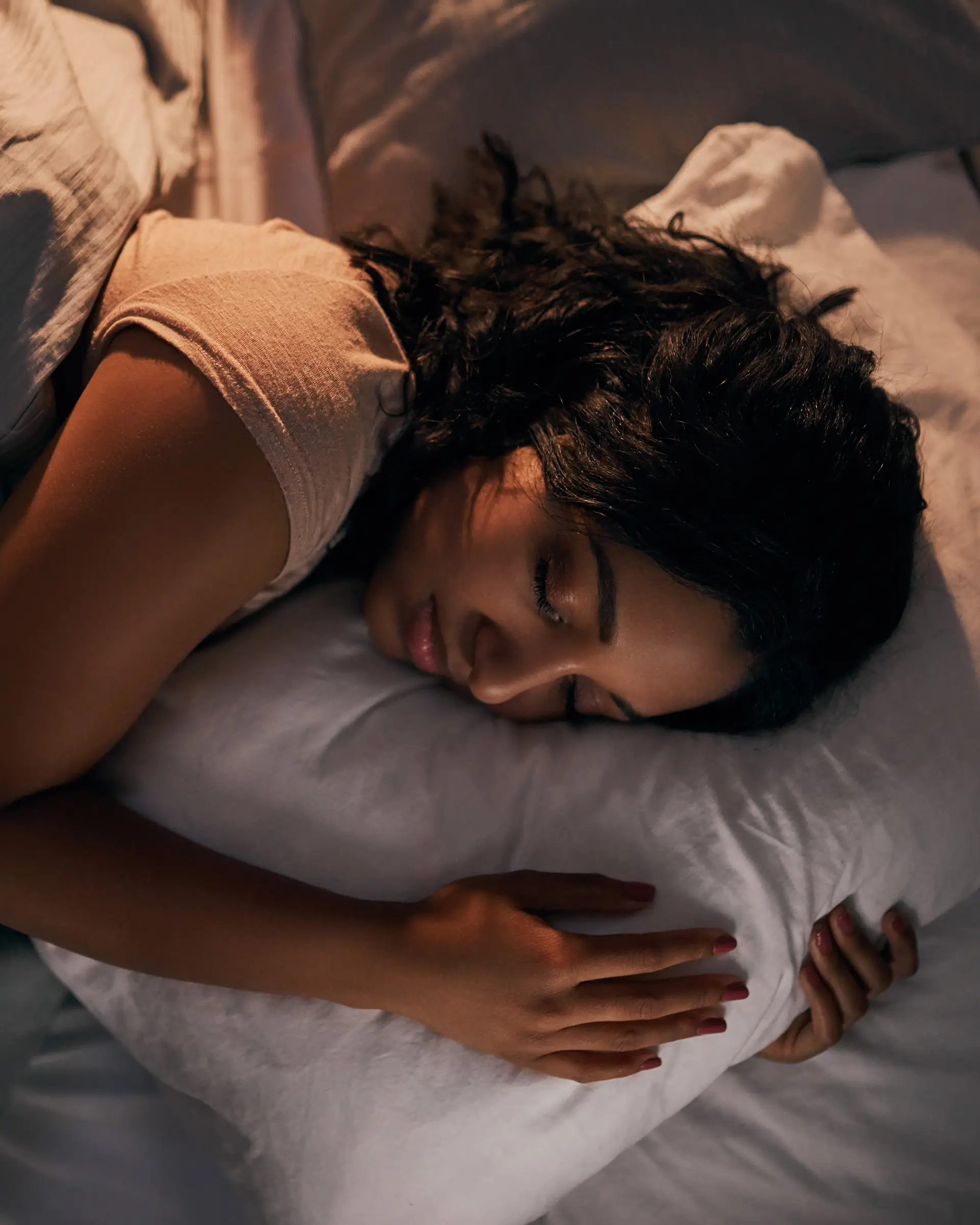 Woman sleeping soundly on pillow.
