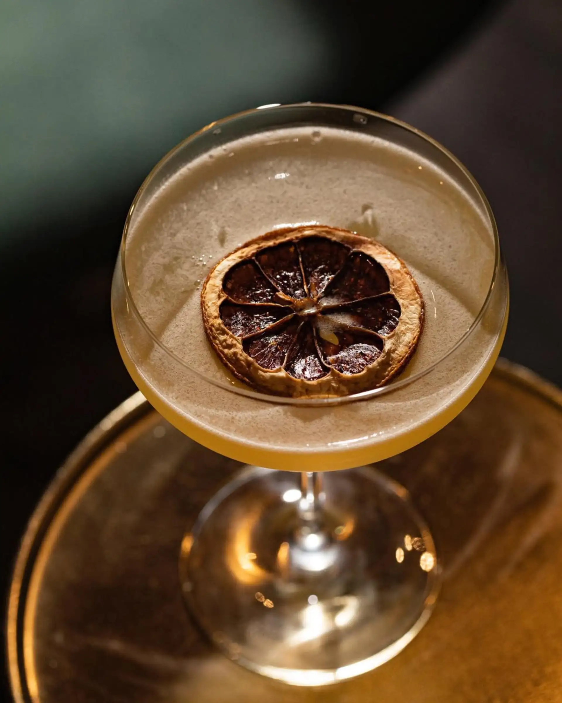 Cocktail with dried orange slice.