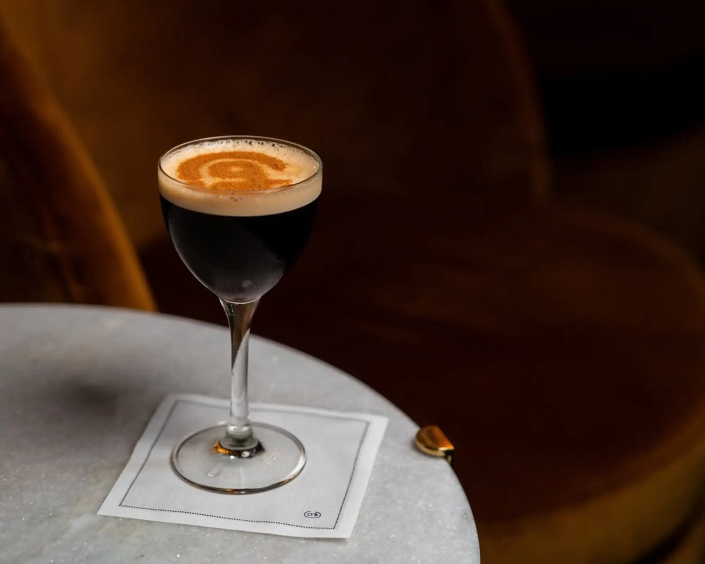 The George logo in cocoa powder on top of a drink.