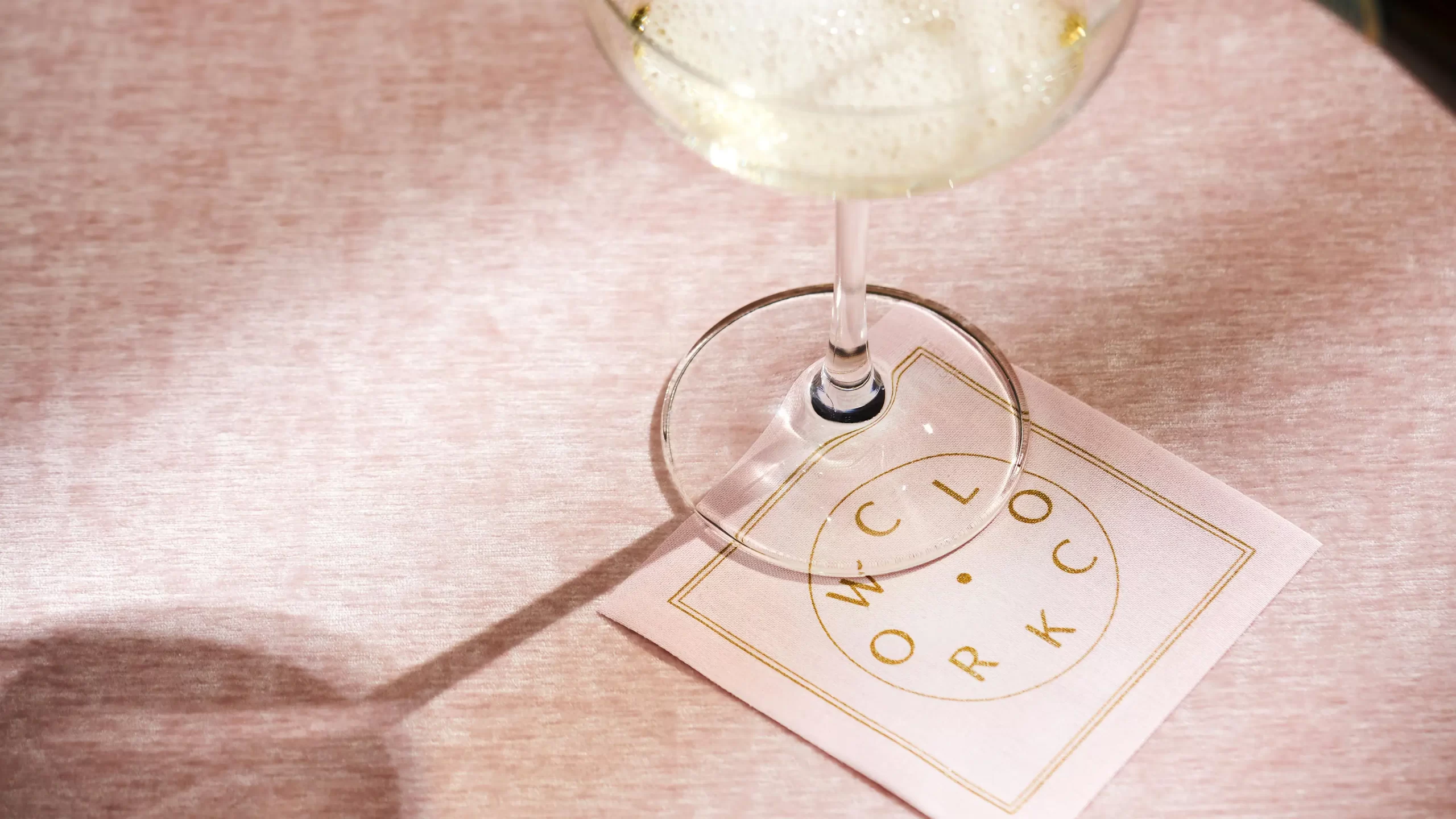 Coaster design with a glass of wine sitting on top.