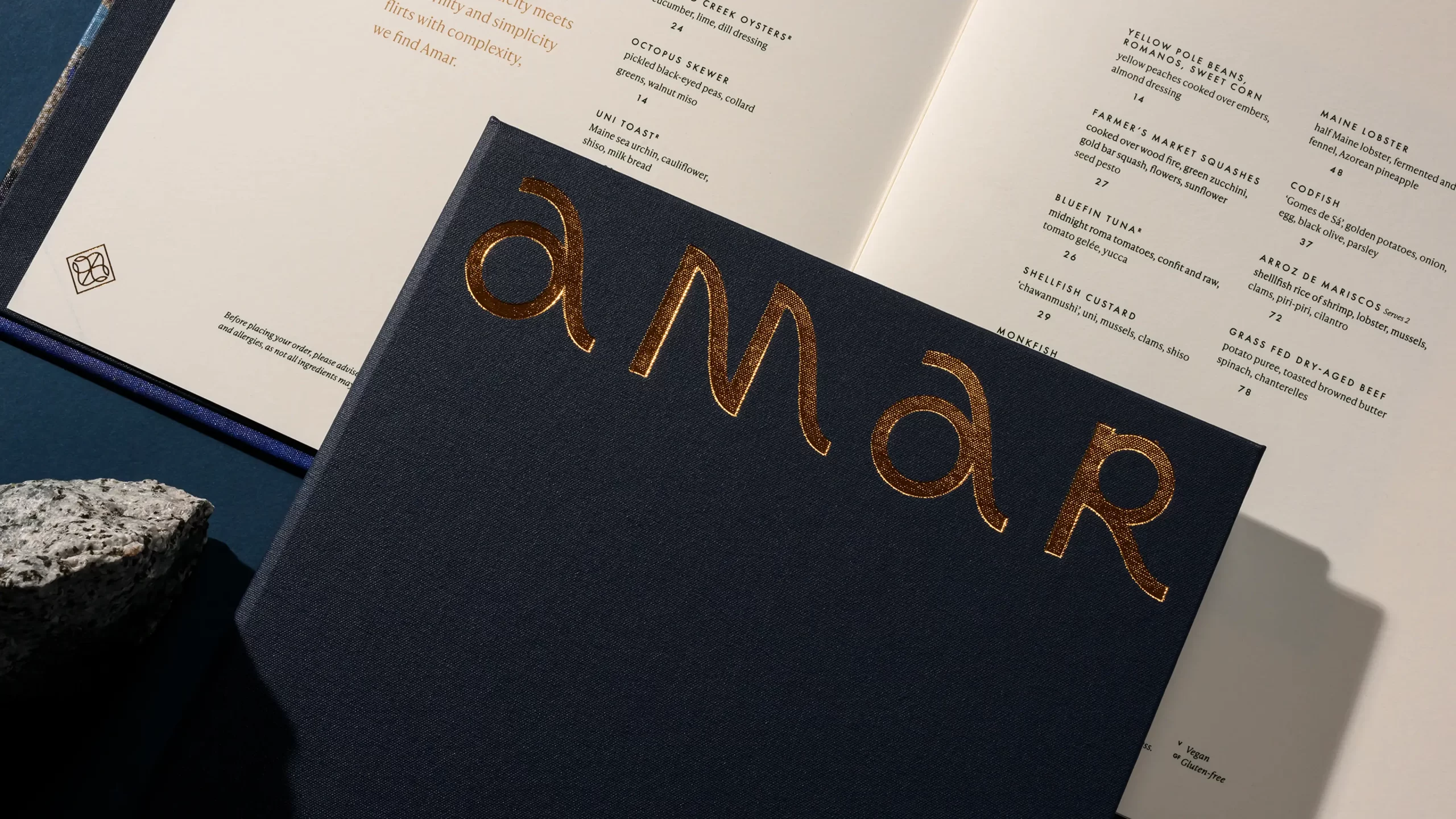 Amar menu cover with gold foil detail.