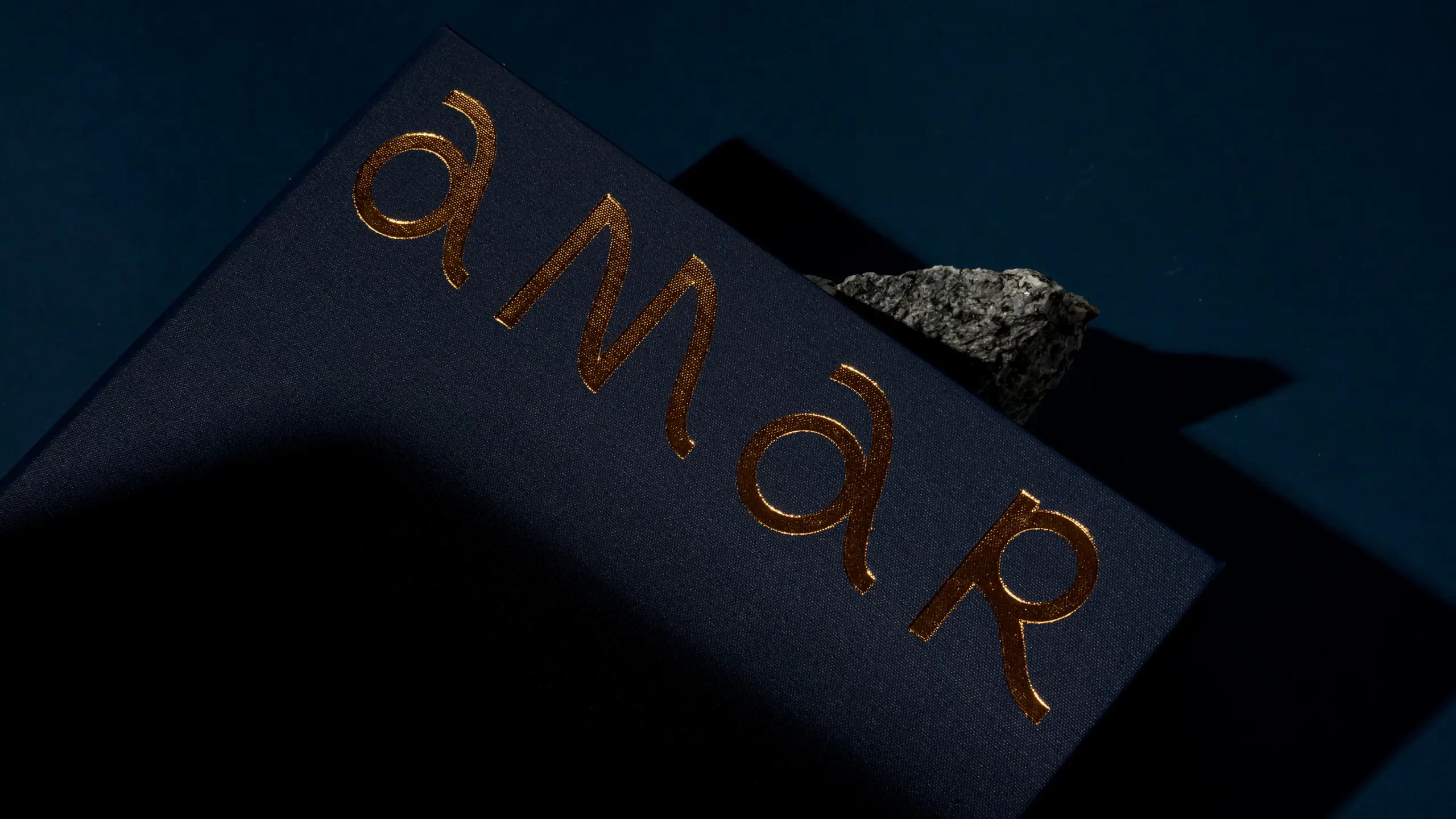 Amar menu cover with gold foil detail.