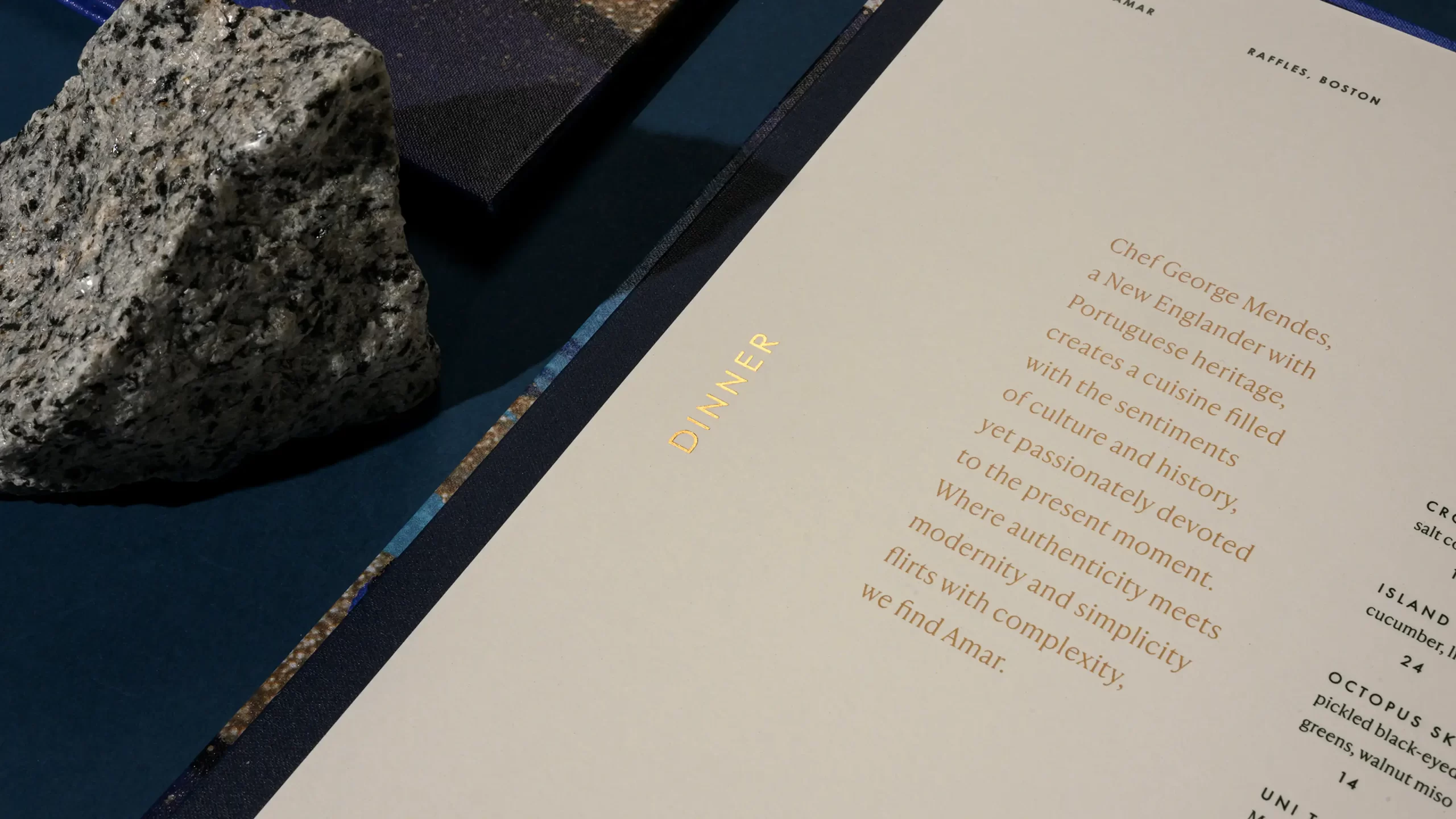 Amar menu interior with gold foil detail.