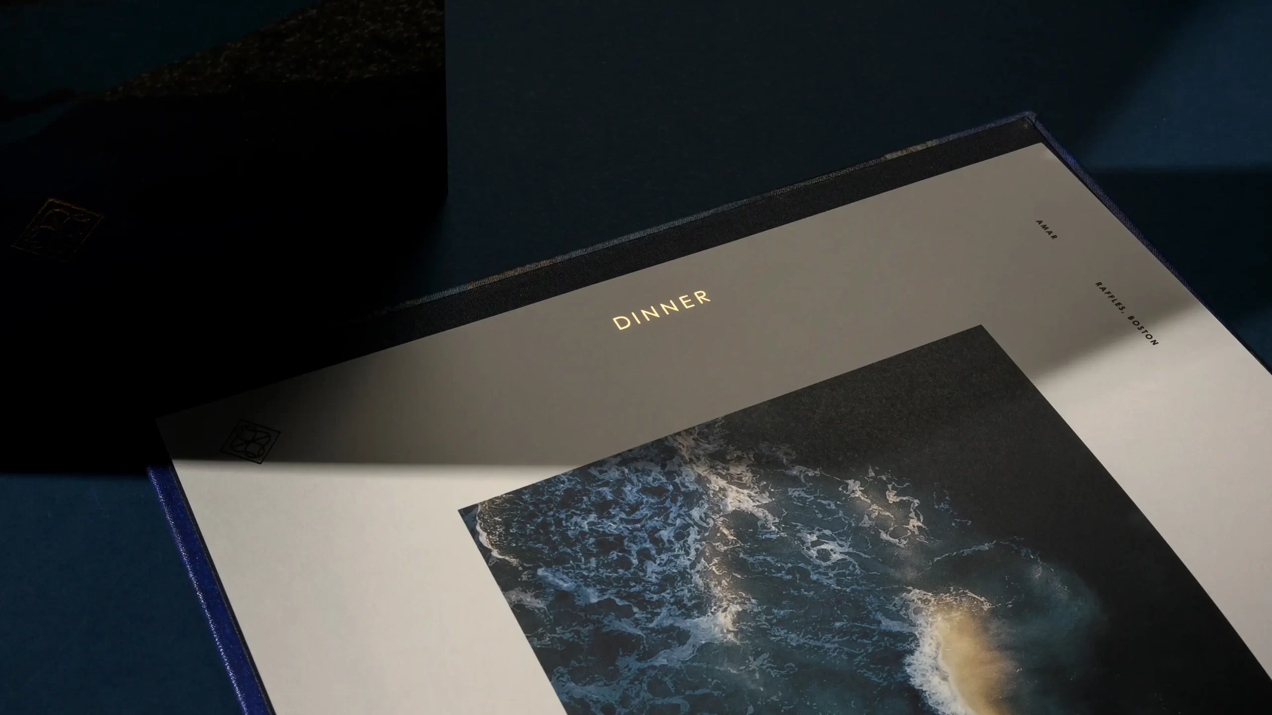 Amar menu cover interior with gold foil detail.