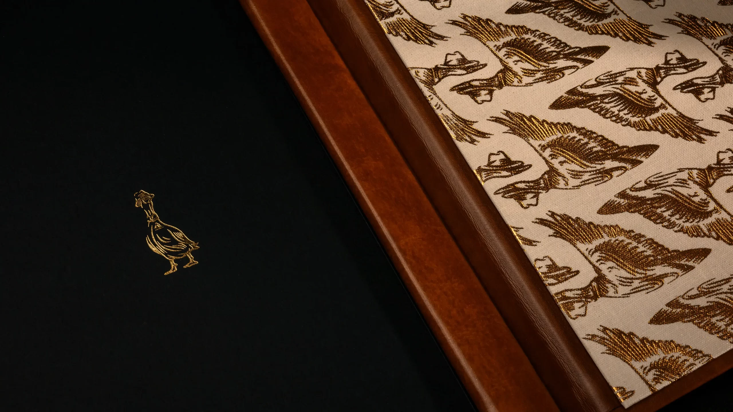 Blind Duck menu interior with gold foiled brand illustrations.